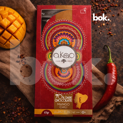 Chocolate dark 70% con mango y chili, empaque premium de diseño artístico en escena lifestyle sofisticada, chocolate ecuatoriano de sabor intenso, curado por BOK Concept Store