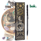 incienso 100% natural de limpieza energetica de BOK Concept Store en empaque negro con detalles dorados sobre superficie de madera en ambiente cálido y elegante