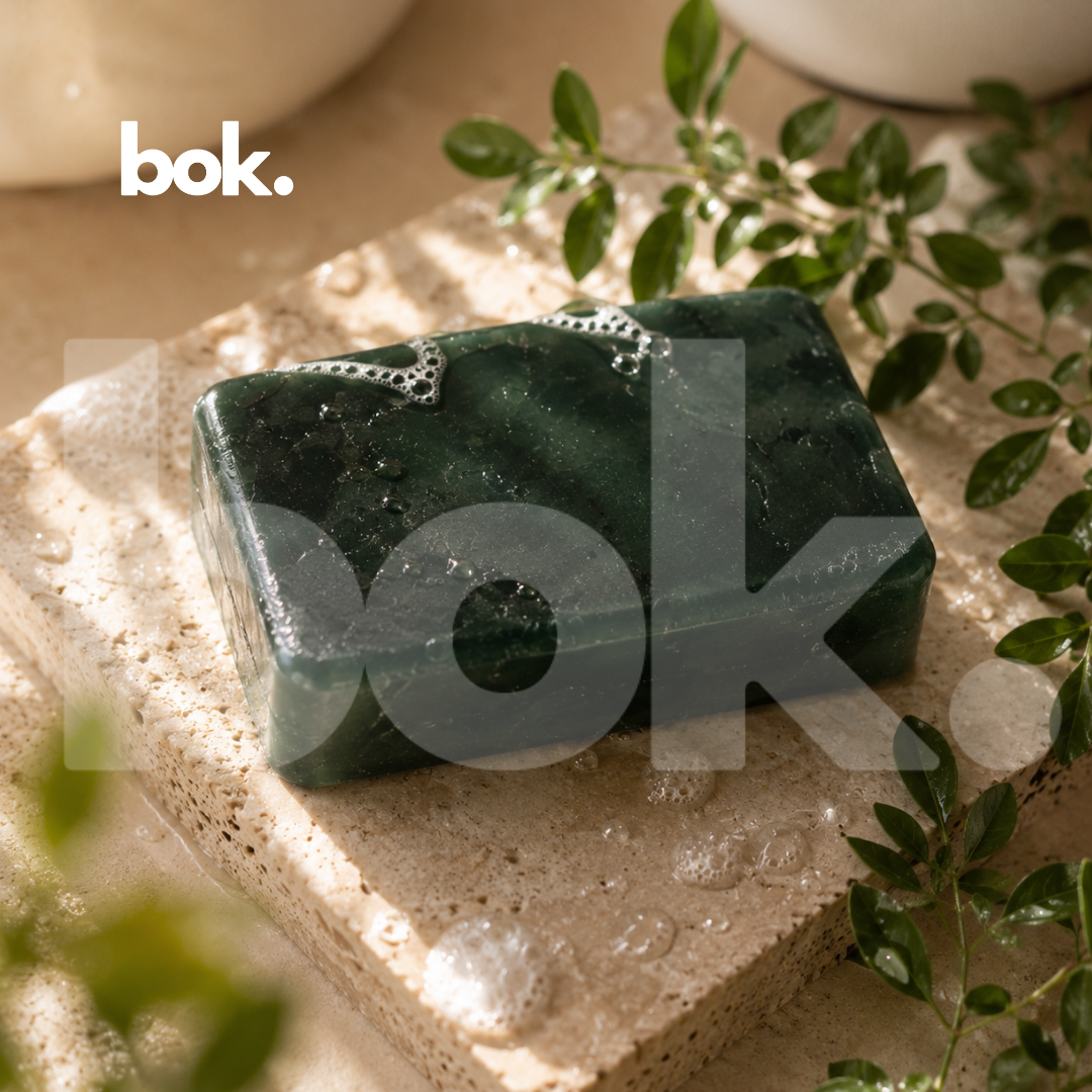 Jabón de Ruda premium de BOK Concept Store sobre piedra natural con hojas de ruda. Cosmética natural elaborada en Ecuador para protección, bienestar, renovación y limpieza energética con ingredientes de origen natural.